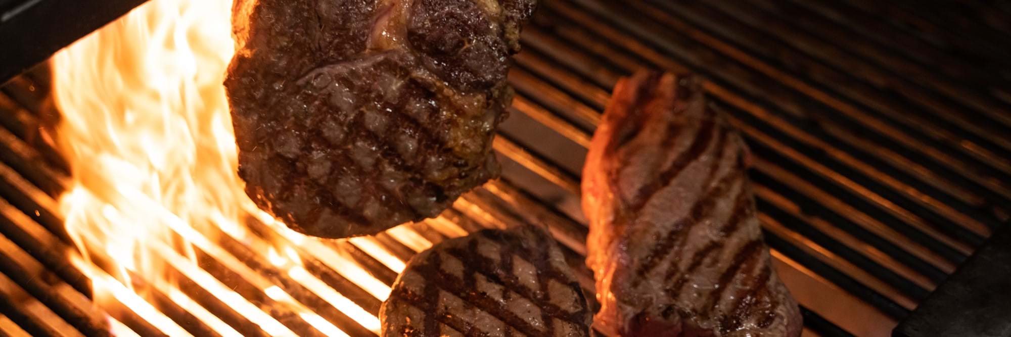 Steak on grill at Zelman Meats restaurant in London